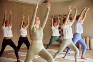 Mensen die yoga op yogamatjes doen in een yogacentrum