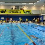 Meerdere zwemmers zijn aan het banenzwemmen in een binnenbad